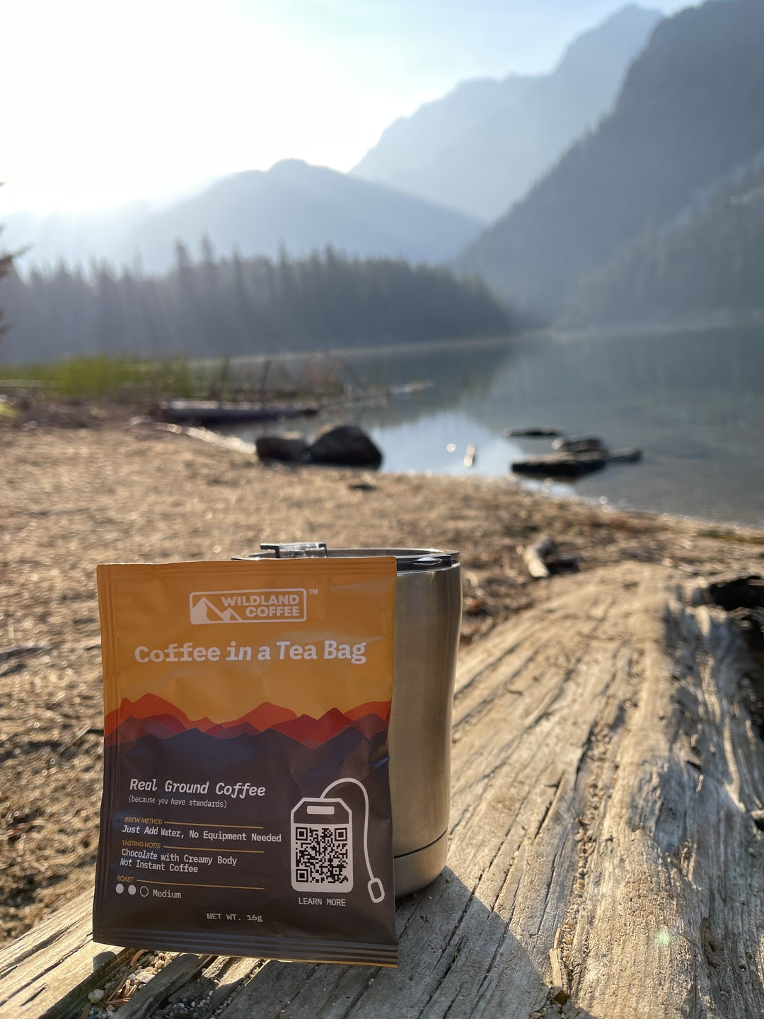 A pouch of Wildland Coffee next to a cup overlooking a lake. This coffee was perfect for my camping trip to the enchantments! So easy to use and delicious! Great before my hike! Can’t wait to have it again!
